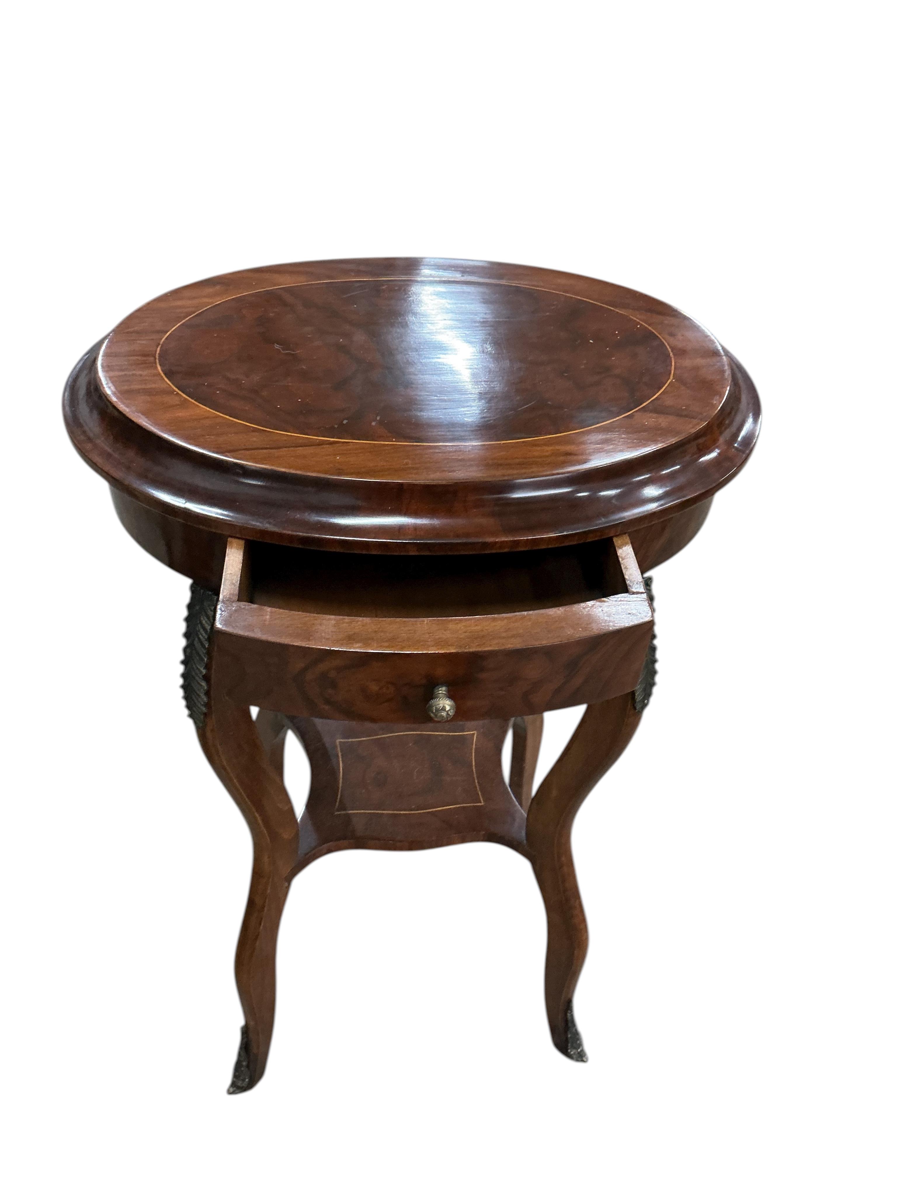 A pair of Louis XVI style oval gilt metal mounted walnut two tier occasional tables, width 45cm, depth 33cm, height 76cm